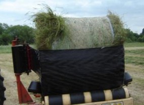 A poorly net wrapped round bale about to have stretchfilm applied.
